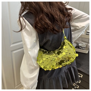 Close-up of bright neon green sequin hobo bag with reflective round paillettes detail