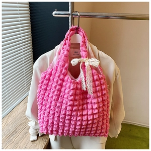 Detailed macro view of pink popcorn fabric tote bag with a white lace bow accent