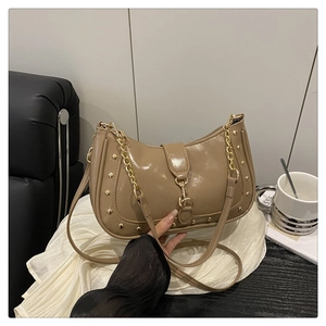 Detail of khaki crescent underarm bag with gold rivets and metallic chain strap