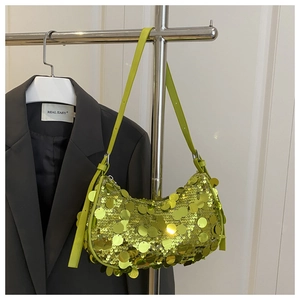 Close-up of lime green crescent bag with sparkling sequins and adjustable shoulder strap