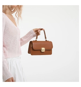 Bolso de mano vintage marrón de piel sintética con suéter rosa y falda blanca