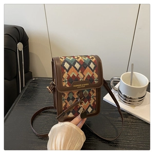 Details der Vintage-Umhängetasche mit buntem Rautenmuster und schmalem Lederriemen