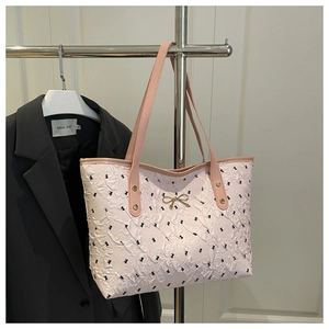 Détail du sac cabas plissé rose avec imprimé nœuds et boucle dorée en forme de nœud