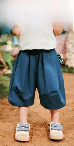 Detail of blue cotton wide-leg kids shorts showing breathable washed fabric and stitching