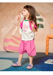 Detail of girls cotton summer set featuring a floral printed T-shirt and pink wide-leg shorts