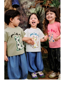 Detail view of kids cotton summer set featuring cartoon prints and wide-leg pants