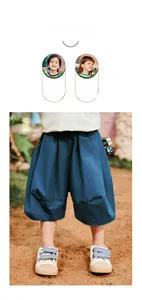 Detail of dark blue cotton loose shorts with elastic waistband on outdoor background