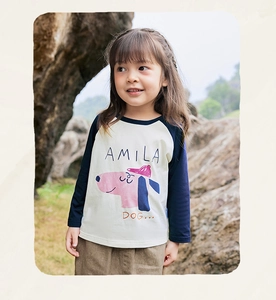 Close-up of girls raglan sleeve tee featuring pink cartoon dog print and amila branding