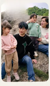 Close-up of family knit sweaters with contrast stitching and kite embroidery detail