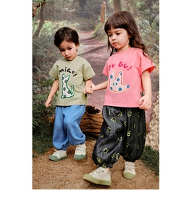 Detail view of kids cartoon printed cotton t-shirts and joggers set in outdoor forest