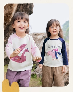 Detail of cotton toddler shirts featuring bunny and dog graphics in outdoor setting