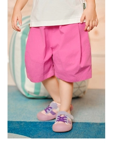 Detail of pink cotton wide-leg shorts for kids with a casual loose fit and draped design
