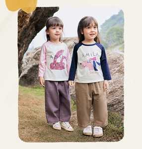 Close-up of cotton long sleeve T-shirt and loose trousers set with cute cartoon prints