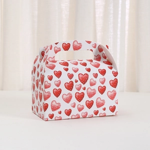 White cardboard gift box with red hearts and handle for Valentine baking and desserts
