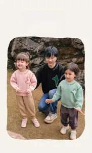 Outdoor shot of kids casual round neck sweaters with colorful contrast stitching details