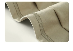 Close-up of khaki ribbed cotton knit fabric showing precise stitching and soft texture