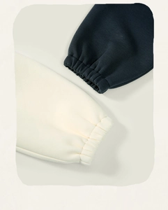 Detail shot of elastic ribbed cuffs on cotton children's dress in black and off-white