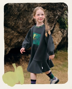 Detail of grey girl's long-sleeve dress featuring green collar and fishtail hem design