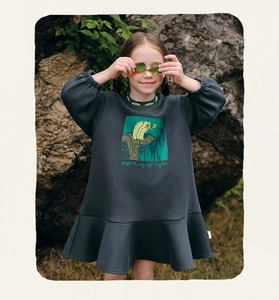 Detail of dark grey girls' sweatshirt dress with forest owl print and ruffled hem