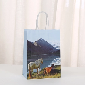 Detail of horse pattern gift bag featuring snowy mountains and white twisted handles