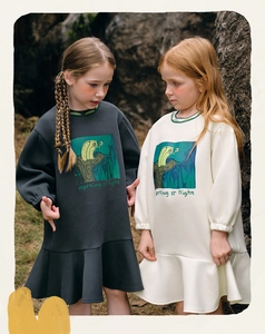 Detail of girls' long sleeve cotton dresses with owl print and ruffled hemline