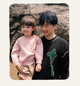 Detail of casual knit sweaters for kids and parents with unique contrast hand-stitched seams