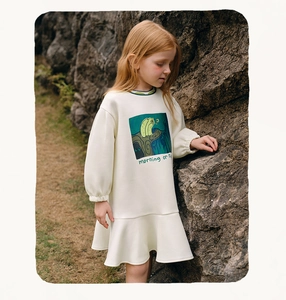 Detail of girls floral printed long sleeve dress with green ruffles and soft cotton fabric