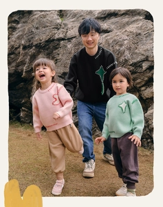 Outdoor shot of cozy knit sweaters with contrast stitching and artistic patches for family