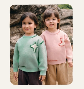 Detail of knit sweater texture with hand-stitched seams in mint green and pale pink