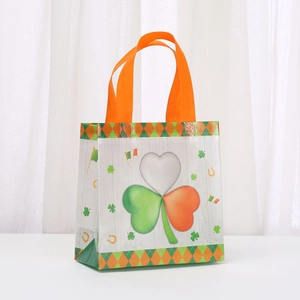 St. Patrick's Day non-woven gift bag with green lucky clover and orange handles
