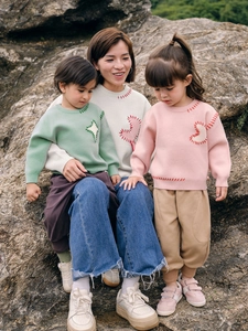 Family matching knit sweaters in cream, mint and pink with contrast stitch detailing