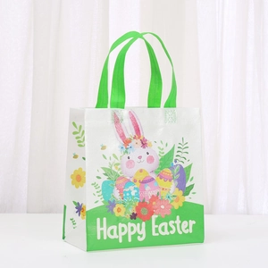 Detailed view of durable Easter non-woven gift bag with rabbit prints and green handles
