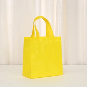 Bright yellow non-woven tote bag with honeycomb texture and reinforced handles