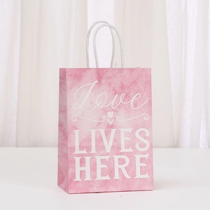 Pink watercolor gift paper bag with tulip design and Love Lives Here text and rope handle