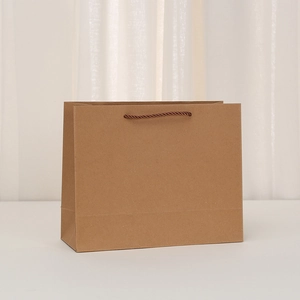 Close-up of premium kraft paper bag with durable brown braided handles and fine texture