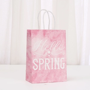 Detail of pink kraft paper gift bag featuring Hello Spring tulip design and paper handles