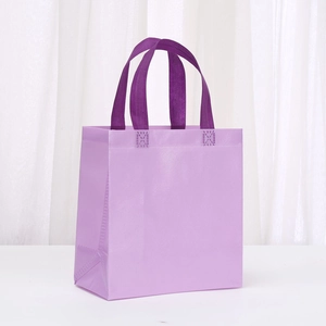 Detailed macro view of reinforced handles and honeycomb texture on the purple gift bag