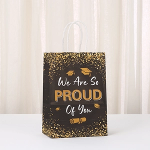 Detail of graduation gift bag with gold glitter We Are So Proud Of You text and white handles