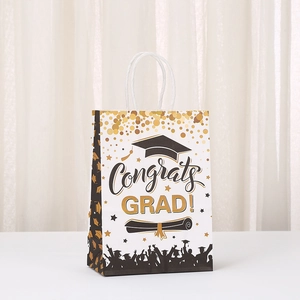 Detail of white graduation gift bag with gold glitter dots and Congrats Grad lettering