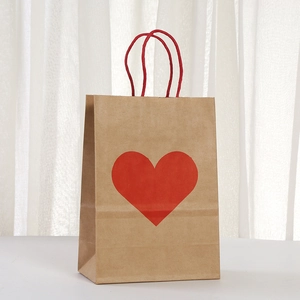 Brown kraft paper gift bag with red heart pattern and red twisted rope handles