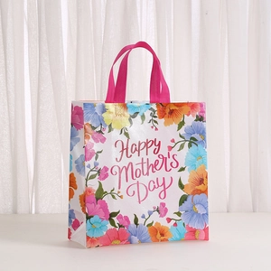 Détail du sac cadeau floral de fête des mères avec texte imprimé et anses roses
