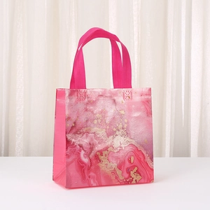 Waterproof pink marble non-woven gift bag with golden texture and ribbon handle