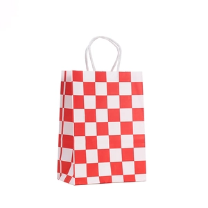 Detail of red and white checkered kraft paper gift bag with sturdy white rope handles