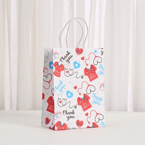 Nurses Day gift bag with cartoon medical patterns of stethoscopes and white twisted handles
