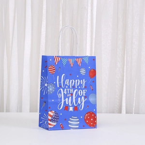 Detailed view of Fourth of July paper gift bag with festive prints and white rope handle