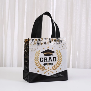 Close-up of black and gold graduation gift bag featuring GRAD print and doctoral cap