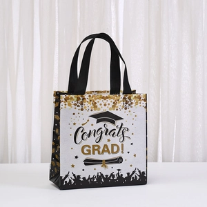 White non-woven graduation gift bag with gold Congrats Grad print and black handles