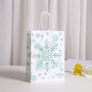 Sac cadeau en papier kraft blanc avec motif de flocons de neige et poignées solides