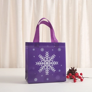 Purple non-woven tote bag with white snowflake patterns and festive holiday decorations