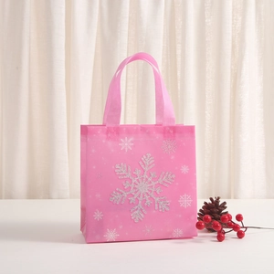 Pink non-woven Christmas gift bag with silver glitter snowflake and festive pine cones